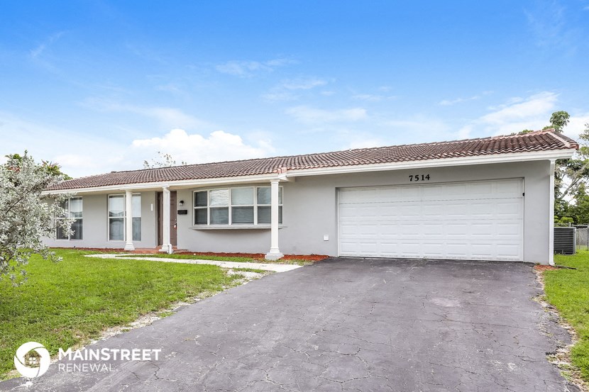 a home with a white garage door and a driveway