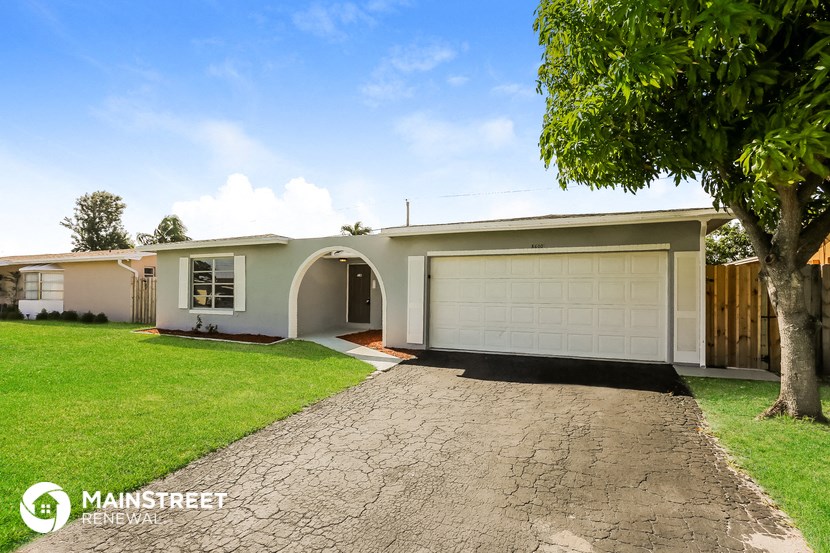 a home with a driveway and a garage door