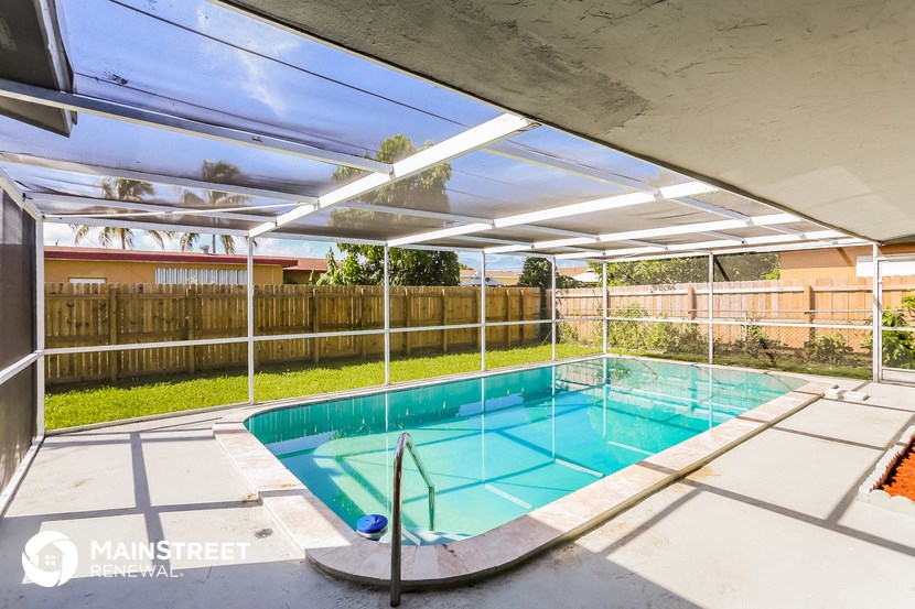 a swimming pool in a backyard with a fence and a pool