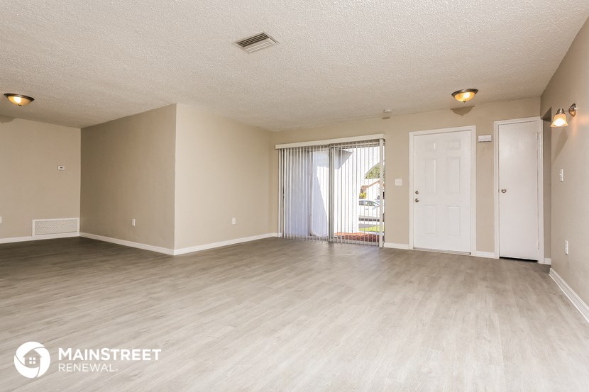 the living room and dining room of an apartment