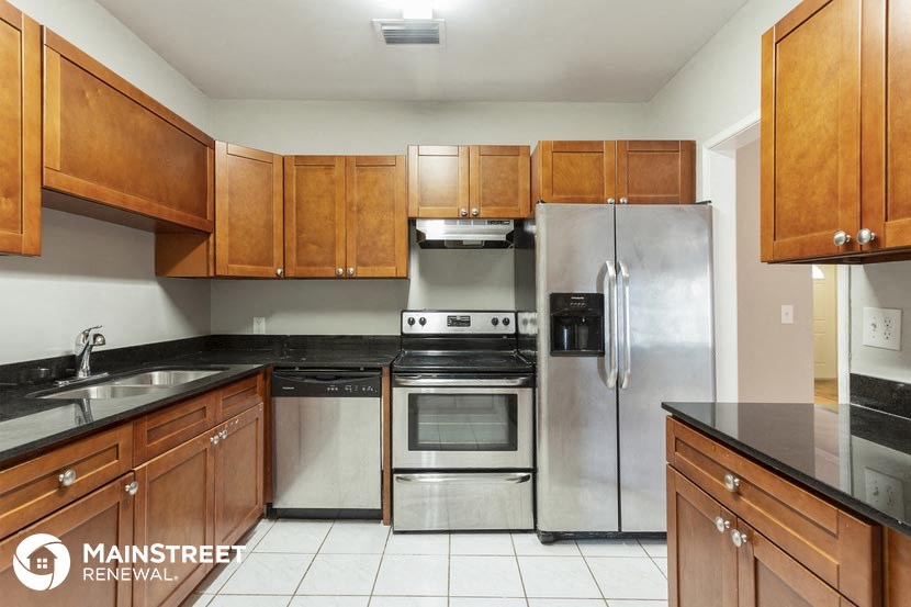 a kitchen with stainless steel appliances and wooden cabinets