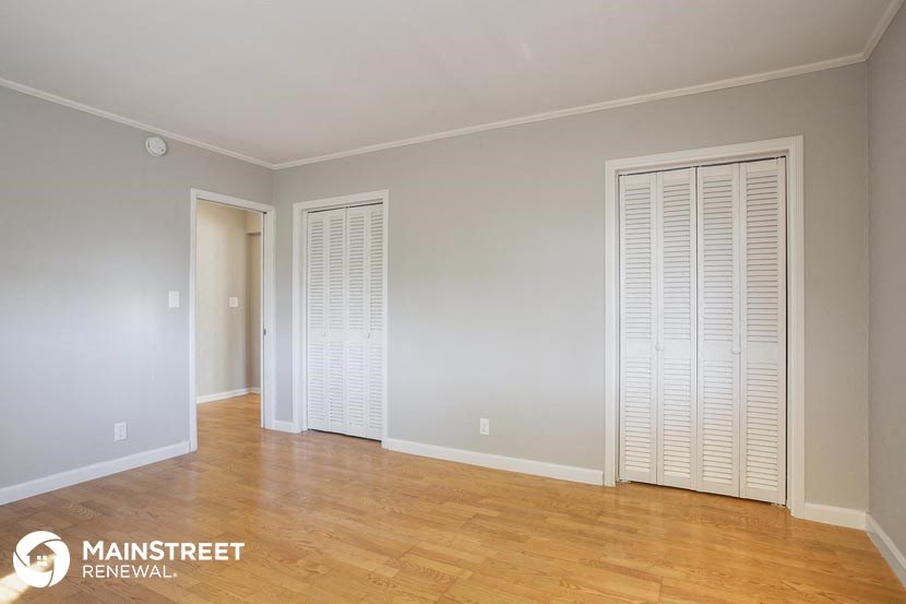 the living room of an empty apartment with a wood floor