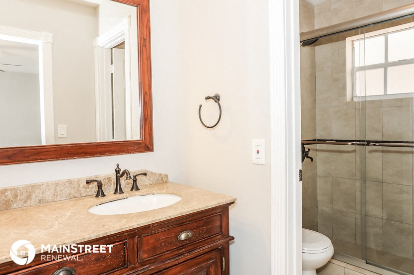 a bathroom with a sink and a mirror and a shower