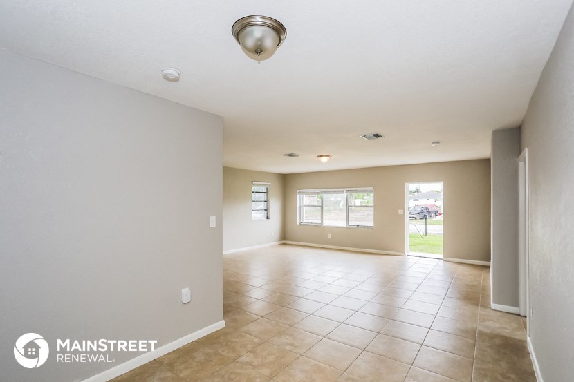 the spacious living room and formal dining room with tile flooring