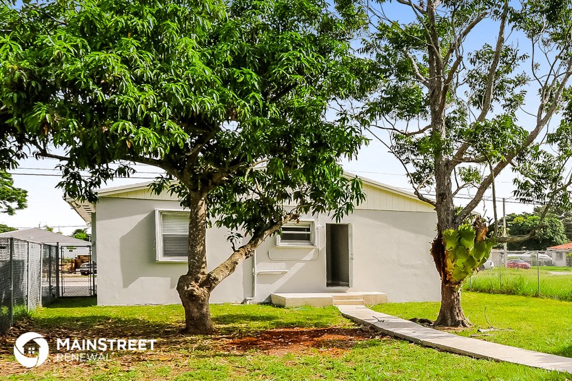 a house with two trees in front of it