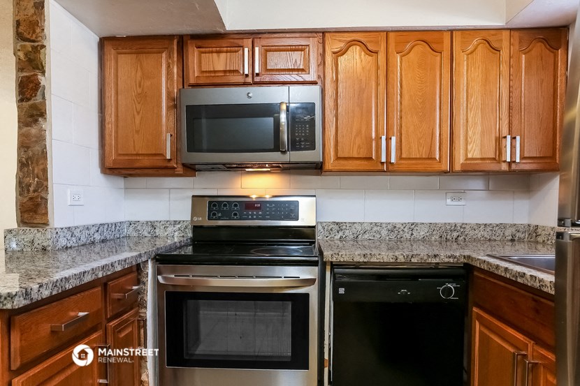 a kitchen with stainless steel appliances and wooden cabinets