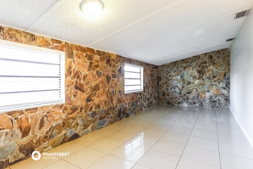 a room with a stone wall and a tile floor