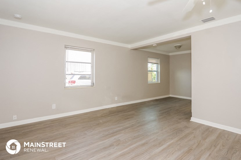 the living room of a new home with wood floors and white walls