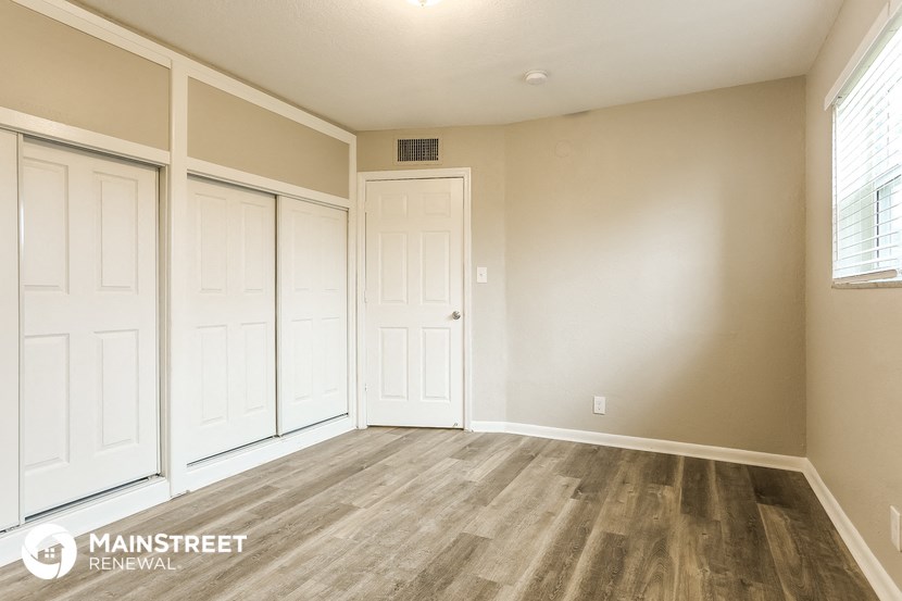 the living room of a new home with white walls and wood floors