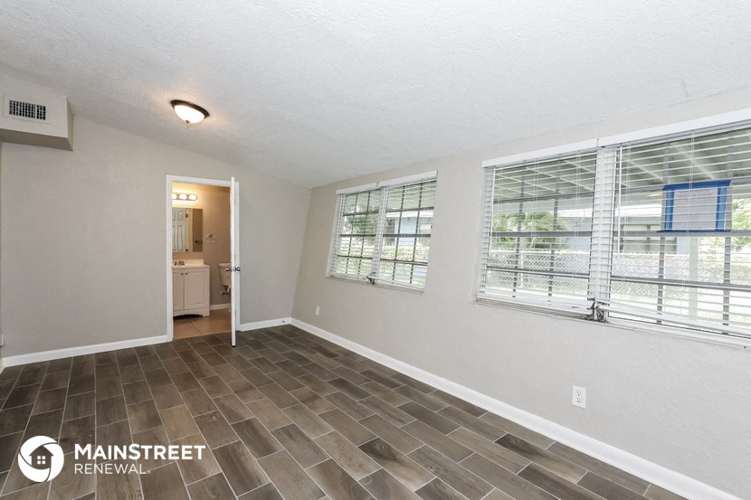 the living room is spacious and has a large window