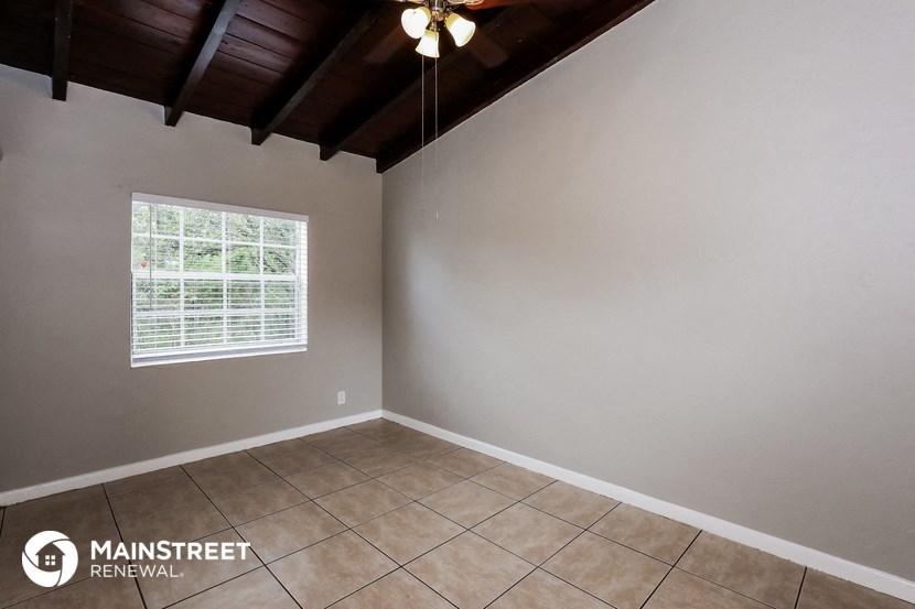 the living room of a home with a tiled floor