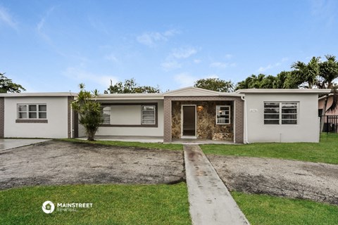 a white house with a yard and a sidewalk