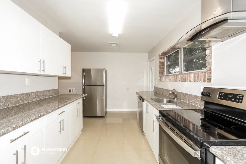 a kitchen with granite counter tops and stainless steel appliances