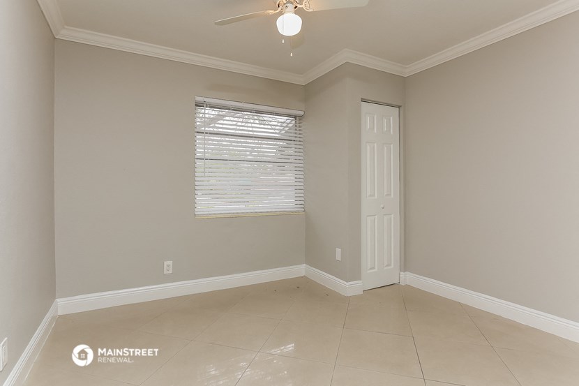 an empty room with a door and a window