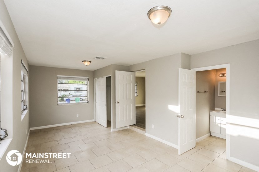 a large room with a sink and a door to a bathroom
