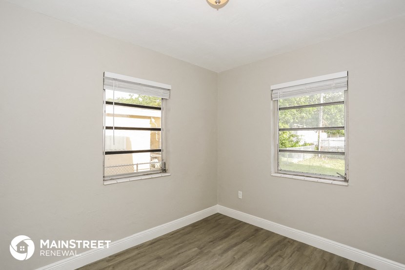 the living room of a home with two windows