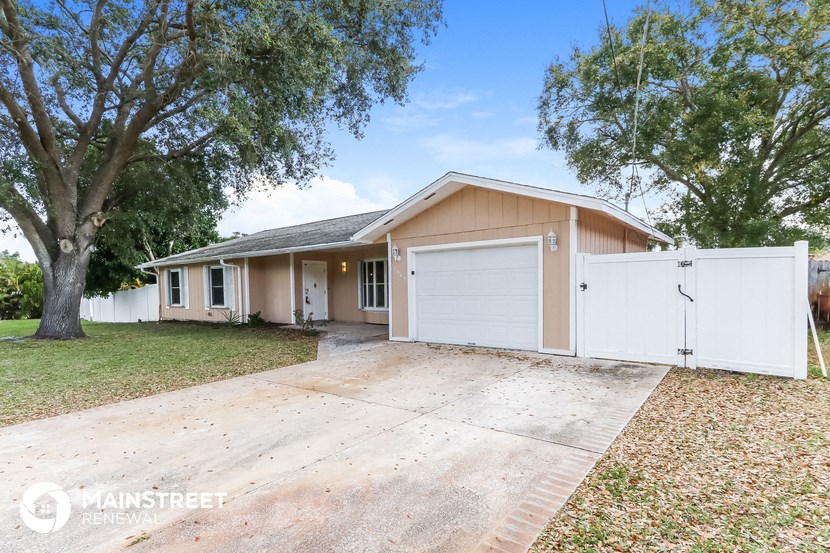 a home with a white garage door and a driveway