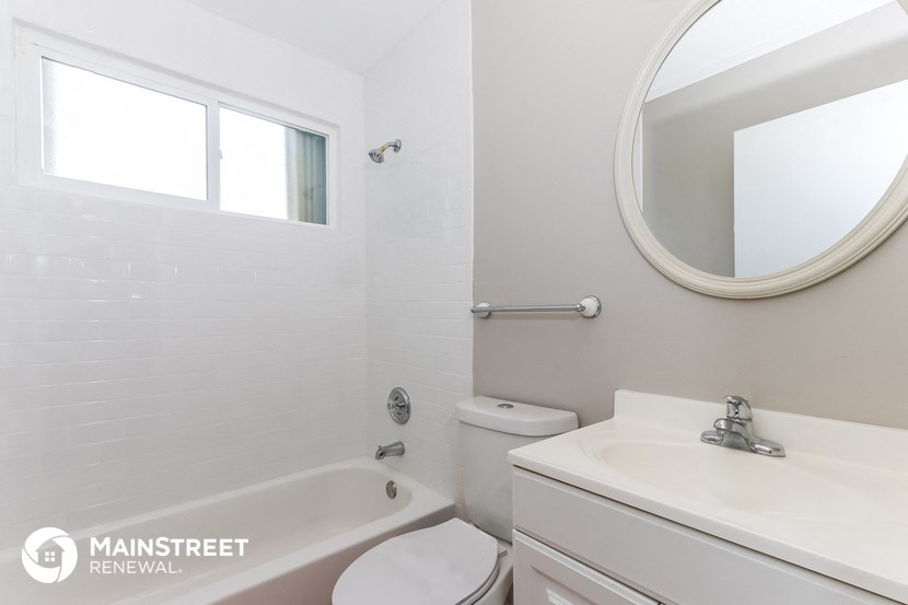 a white bathroom with a sink toilet and bath tub