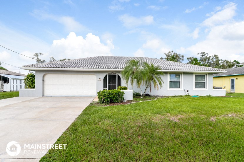 a white house with a palm tree in front of it