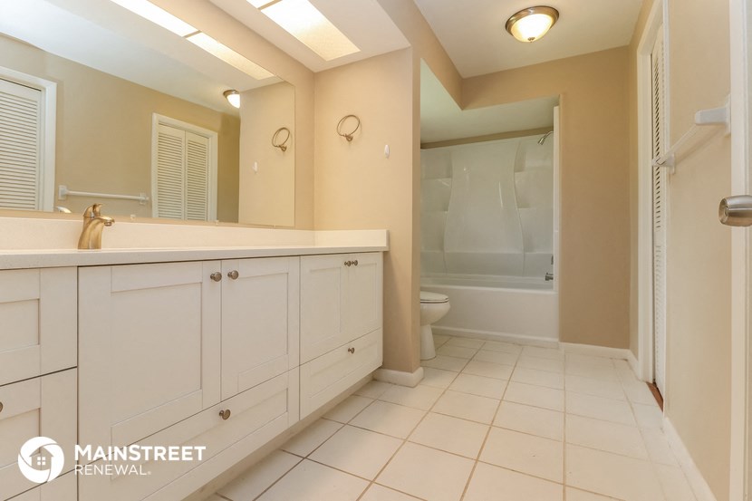 a bathroom with a sink and a toilet and a shower