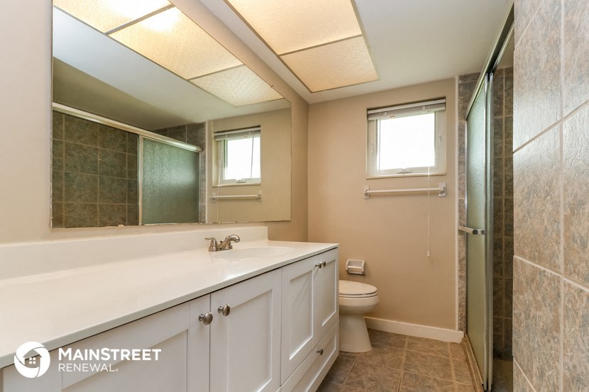 a bathroom with a sink and a toilet and a shower