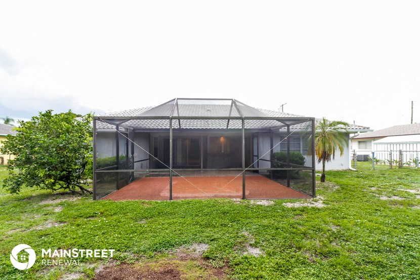 a tennis court in a cage in a yard