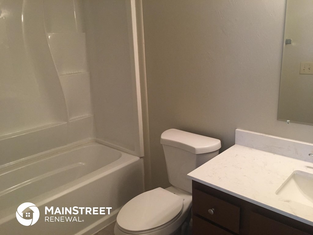 a small bathroom with a toilet and a shower