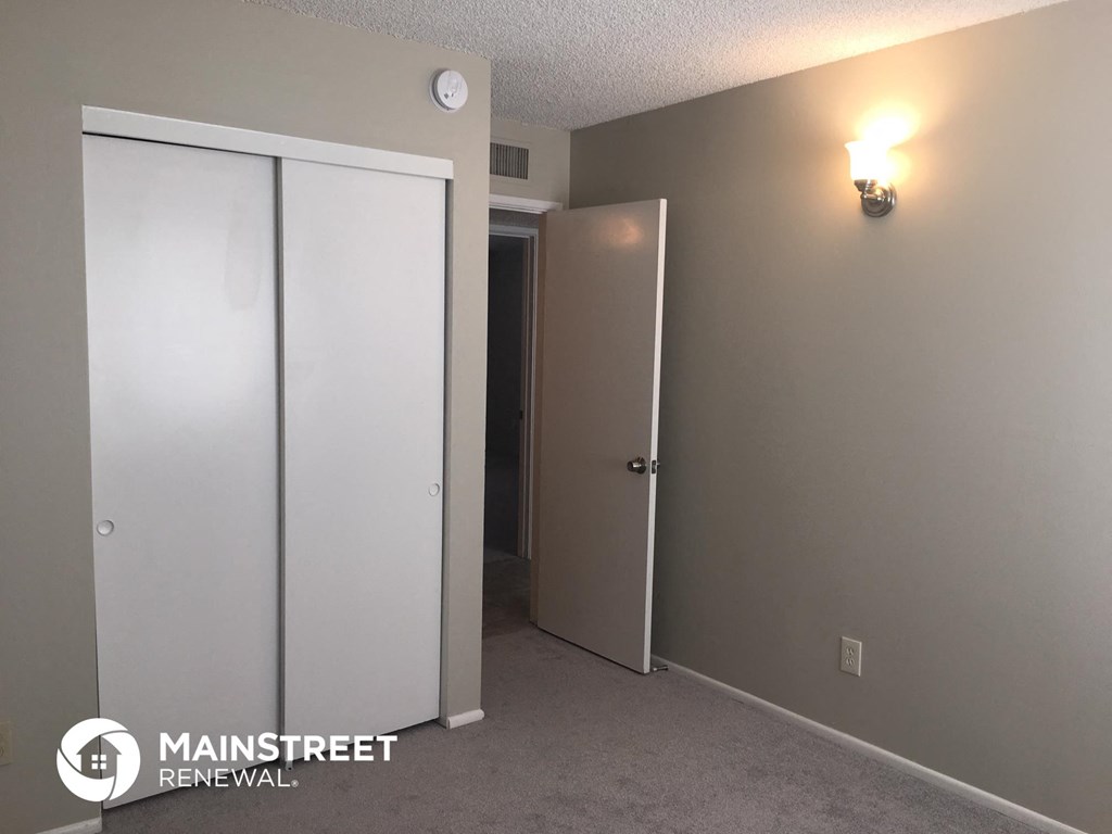 a room with two closets and a light on the wall