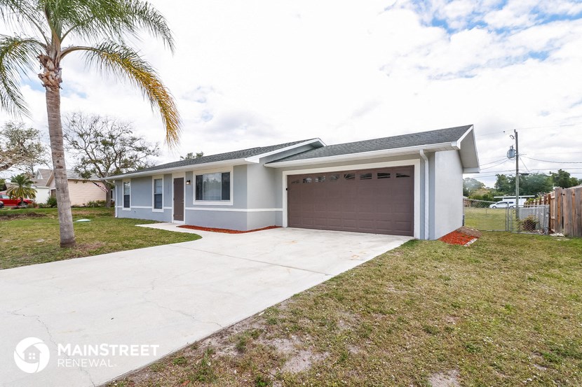 a home with a driveway and a garage door