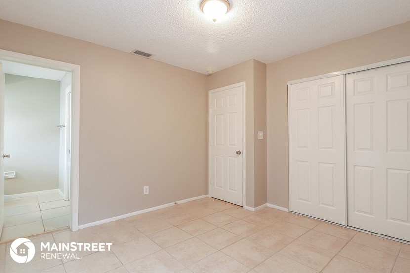 the upstairs laundry room has two closets and a tile floor