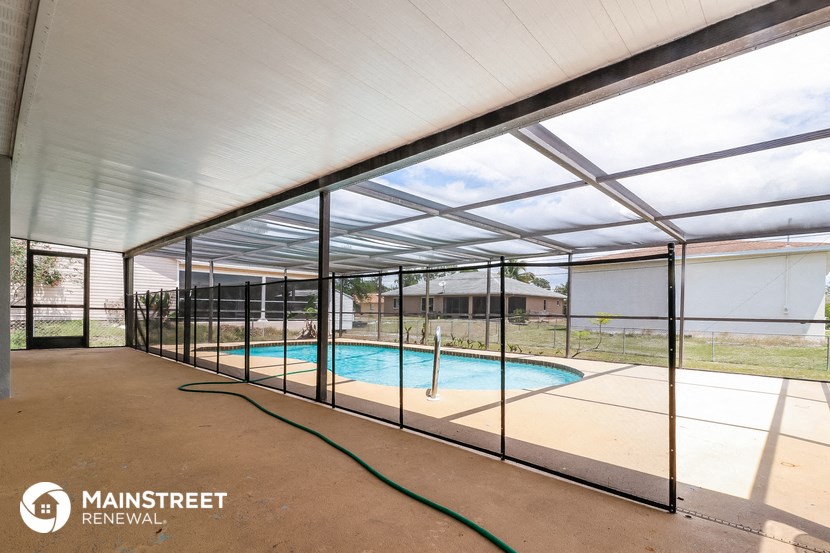a large swimming pool under a glass enclosure in a house