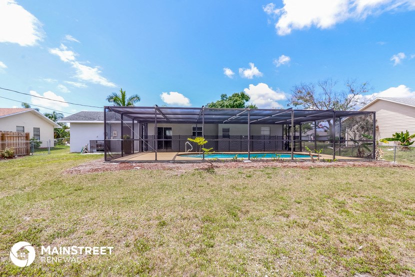a backyard with a pool and a house