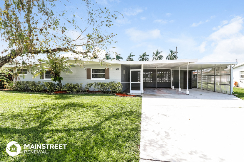 a house with a garage and a lawn in front of it