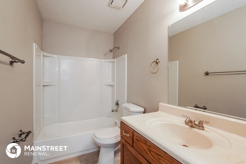 a bathroom with a sink and a toilet and a shower
