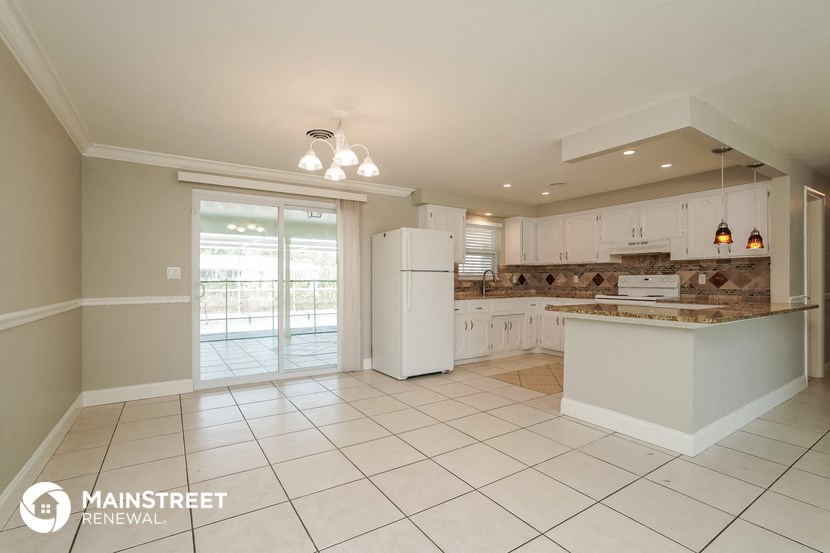 the kitchen is open to the dining room and living room