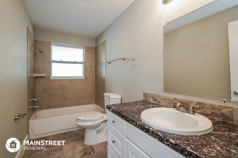a bathroom with a sink and a toilet and a bath tub