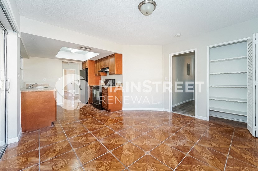 a renovated kitchen with stainless steel appliances and tile flooring