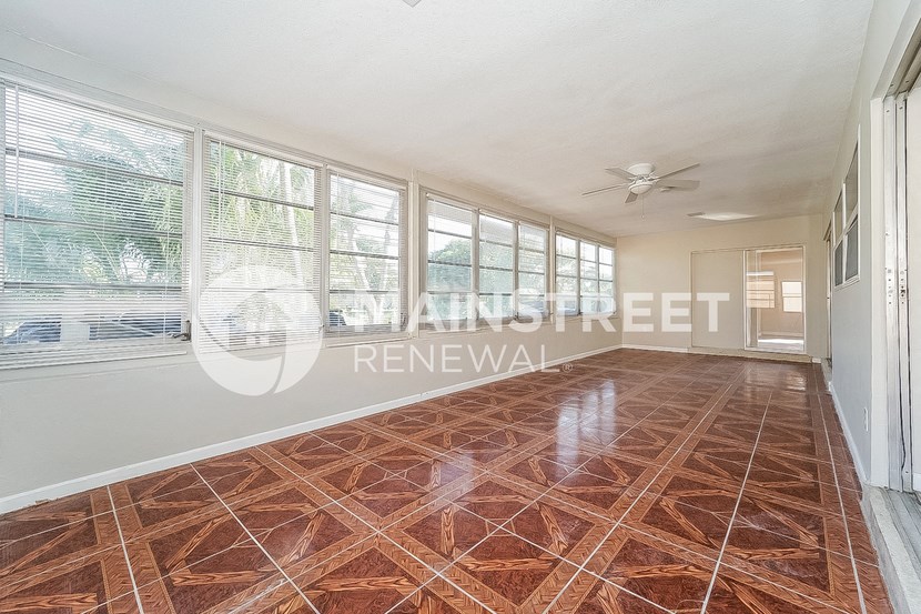 a living room with large windows and a marble floor