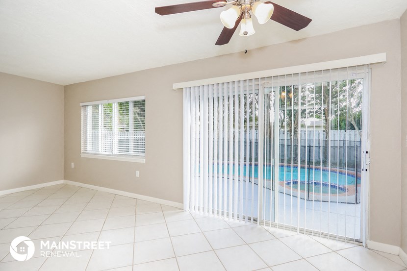 a living room with a pool and a ceiling fan