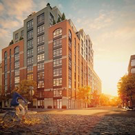 a person riding a bike in front of a building