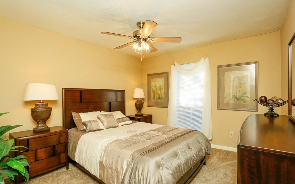 a bedroom with a bed and a ceiling fan