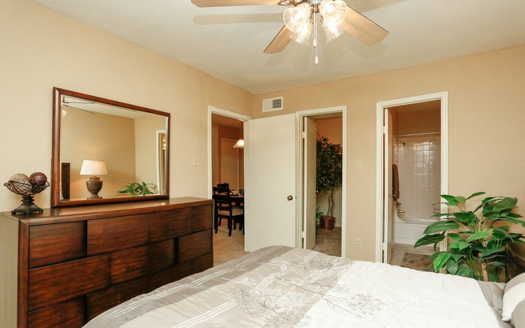 a bedroom with a large bed and a ceiling fan