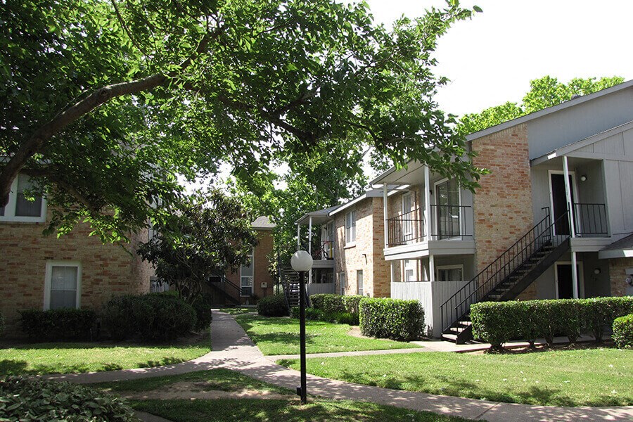 a sidewalk in front of an apartment building