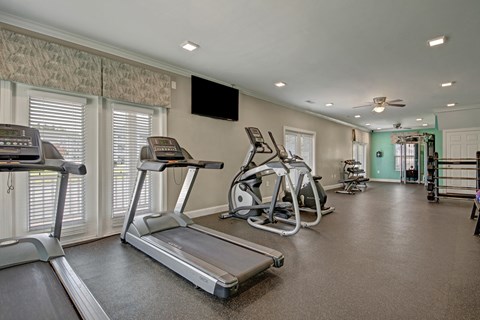 On-site fitness center with cardio and strength equipment at Canterbury Apartments in Myrtle Beach, SC