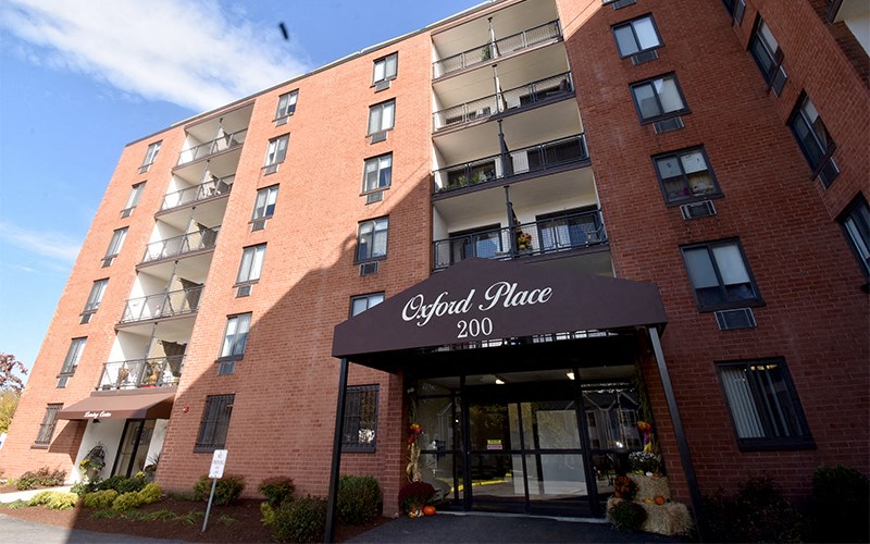 a red brick building with a black awning and the word georgi