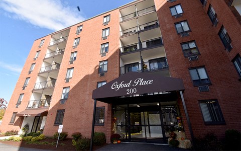 a red brick building with a black awning and the word georgi
