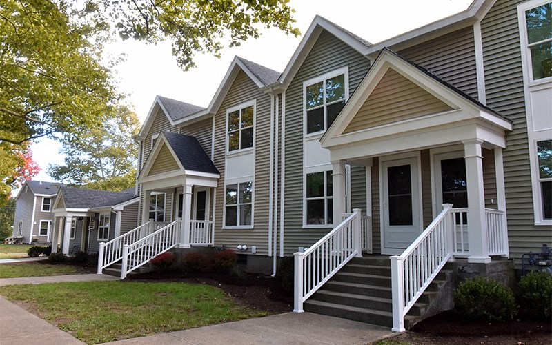 a row of houses with stairs and a porch