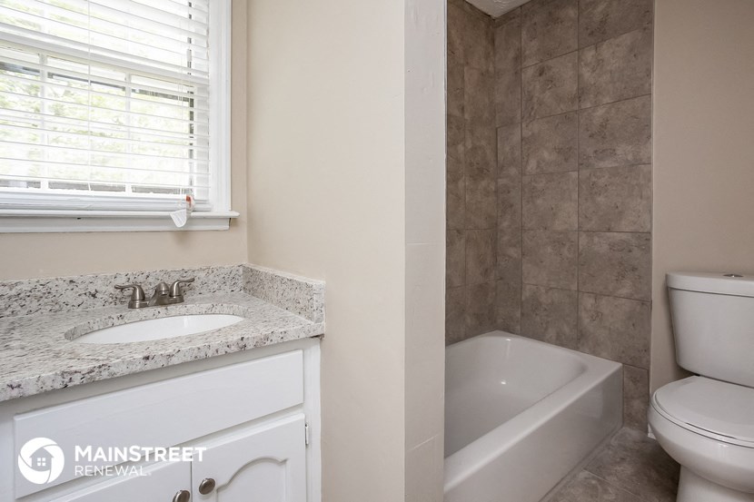 a bathroom with a sink and a toilet and a bath tub