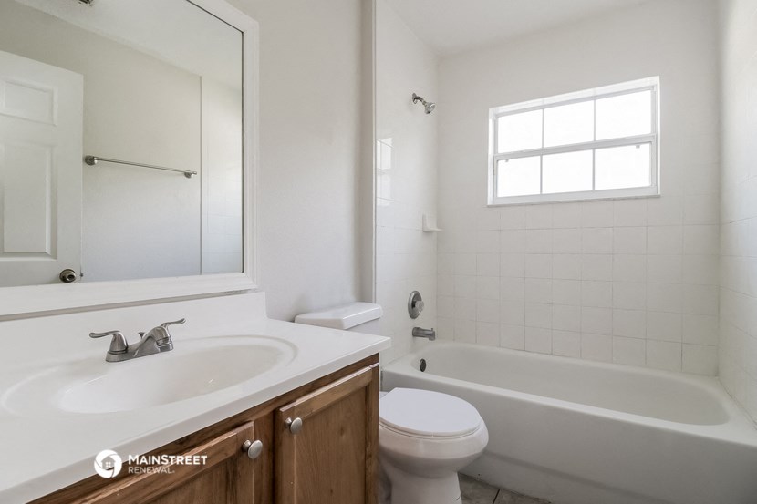 a bathroom with a sink and a toilet and a bath tub