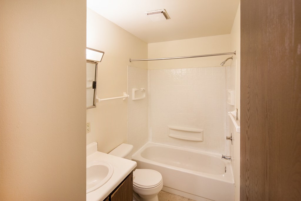 a bathroom with a sink toilet and a tub